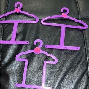 Purple plastic doll clothes hangers lot